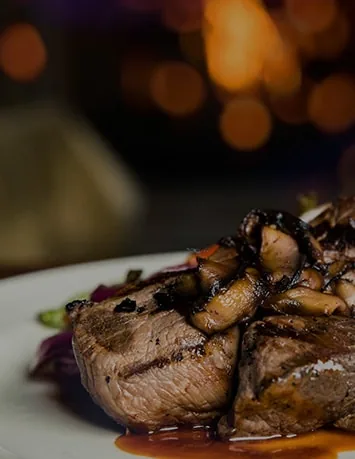 Grilled steak medallions with mushrooms