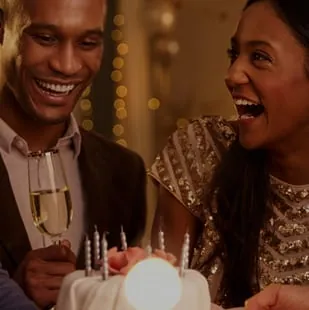 A couple celebrating with a cake at the lodge